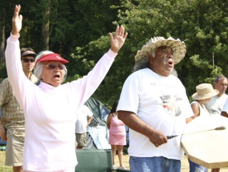 Lootie and Smitty Hillaire of the Lummi Indian Nation welcome canoes to Roche Harbor during the 2004 Canoe Journey. Canoes are visiting the San Juans this week en route to the territory of the Cowichan First Nation in Duncan