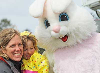 The Easter poses for photos with fans moments before the start of annual Easter Egg Hunt at Jackson's Beach