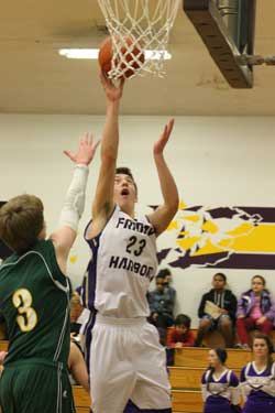 Up and in; Friday Harbor's Peter Strasser scores two points at the rim in the Wolverines 66-21 runaway win over Darrington