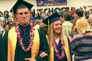 Friday Harbor High School Class of 2013 graduates Ryan Allen and Jean Melborne stroll through an enthusiastic crowd at the outset of the school’s 101st commencement ceremony