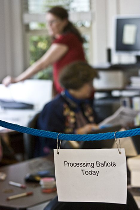 The Elections Department's A team processes ballots Tuesday in the elections office in Friday Harbor. Almost 50 percent of all ballots had been received in the elections office by noon today.