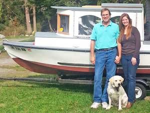 Jeff and Linda Patterson pose in front of the Big Dipper with their portly dog