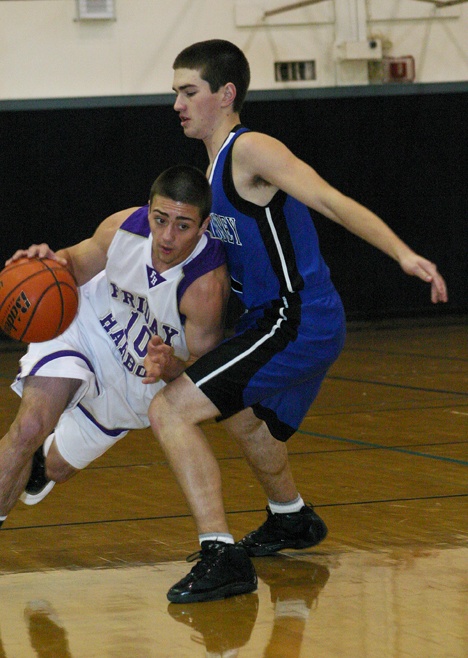 Friday Harbor’s Mike Ausilio (10)  muscles past South Whidbey’s Cole Erikson on the way to the front court  Saturday at Turnbull Gym. Ausilio scored seven points against the Falcons.