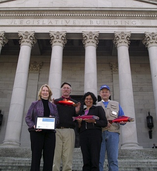 Representatives of the San Juan County Beach Seiners and San Juan County’s Salmon Recovery coordinator pose outside the State Capitol. From left