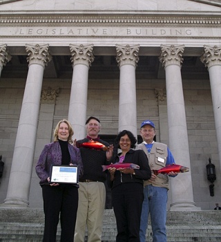 Representatives of the San Juan County Beach Seiners and San Juan County’s Salmon Recovery coordinator pose outside the State Capitol. From left