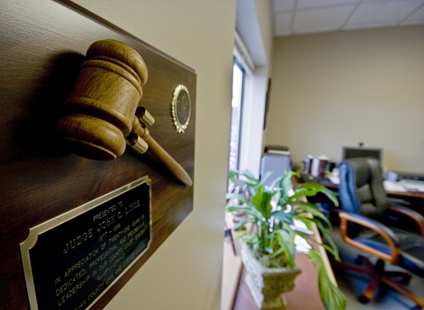 A plaque honoring Superior Court Judge John Linde for his earlier service as a District Court judge decorates his office at the county courthouse. Linde