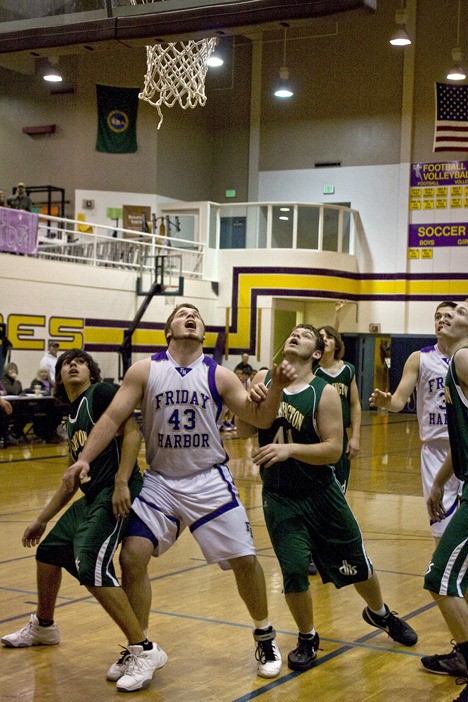 Friday Harbor’s Parker Lawson (43) prepares to snag a rebound during the Wolverines’ easy handling of Darrington