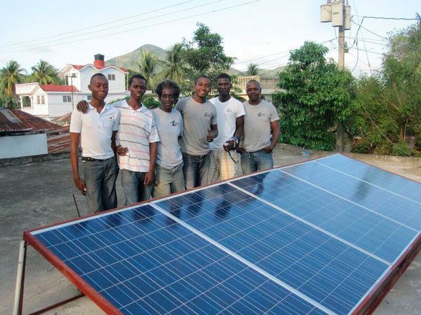 The team with their newly installed solar panel in Haiti.