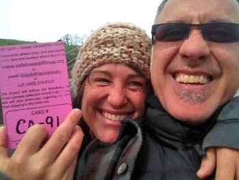 Jennifer of Victoria and a friend show off a drift card that she found on Vancouver Island.