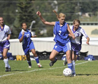 Wolverine Alex MacDonald (3) challenges Falcon Liz Adams at midfield in Saturday’s 7-0 loss to South Whidbey.