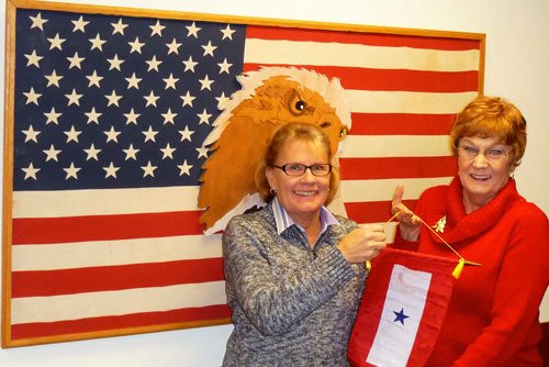 Minnie Knych awarded the Blue Star Banner to Mel Vynne at the Legion's December box packing.  Vynne's son