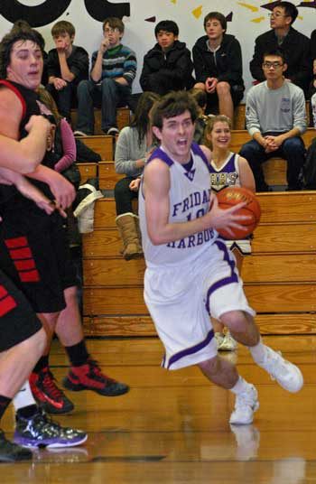 Friday Harbor's Dylan Demaris drives baseline for two in the Wolverines 68-27 runaway win at home