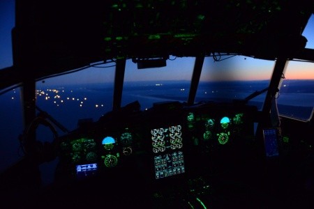 An aircrew aboard an HC-130 Hercules airplane
