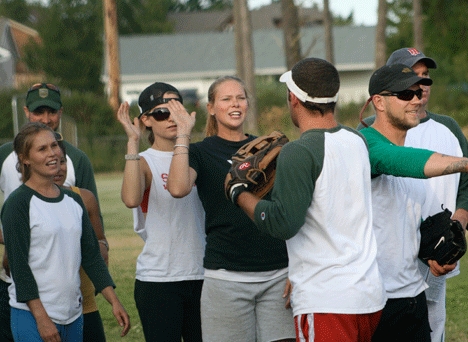 Hot Box team members celebrate as they clinch the B League softball title with a 12-8 victory over the Sea Sluggers July 15.