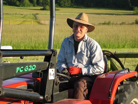 Bruce Gregory in the driver’s seat of a tractor at Mitchell Bay Farms.
