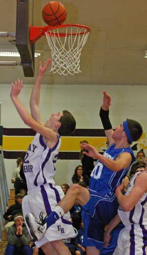 Friday Harbor's Peter Strasser drives past Vikings defender Jack Russillo for a layup and two points in the Wolverines 78-49 win at home