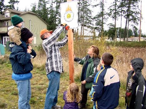 Residents of Sunday Drive Firewise community post their new Firewise sign. Sunday Drive is one of four new Firewise communities in San Juan County.