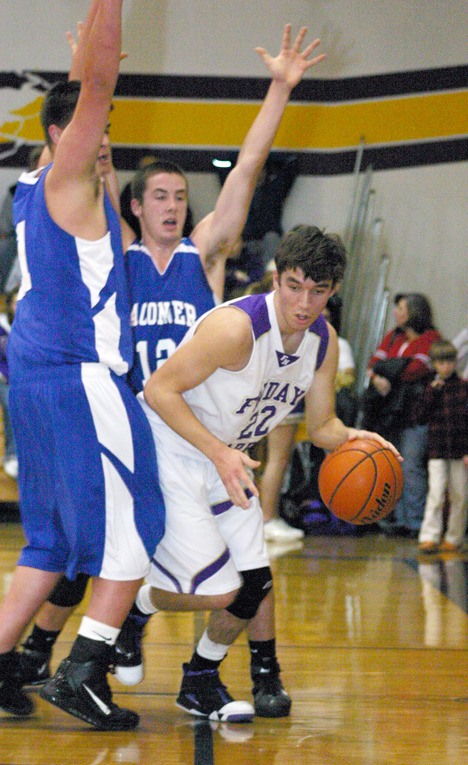 Friday Harbor’s Tanner Buck (22) is trapped on the baseline in the Wolverines’ game vs. La Conner