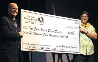 San Juan Public Schools Foundation Treasurer Jim Skoog presents the “big check