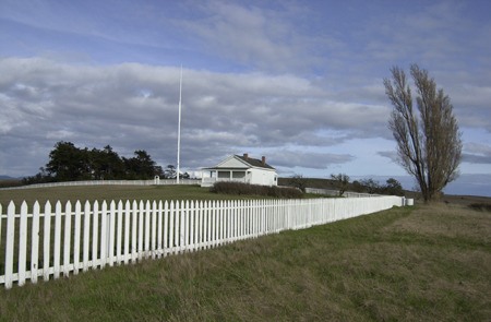 A white picket fence leads to officers quarters at American Camp
