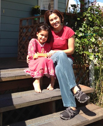 Carmen and Atziry Orozco relax on the front porch of their  Salal Neighborhood home.