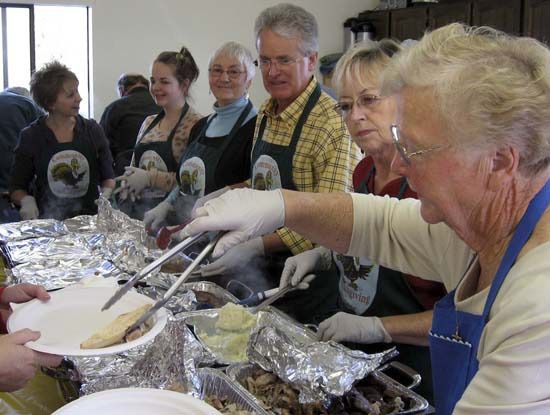 A look at volunteers at the Community Thanksgiving Dinner from the past. There are often so many volunteers that by the end of the day there is hardly any work left to do.
