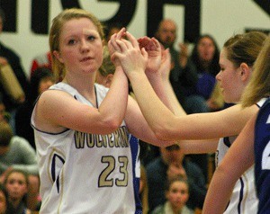 Jean Melborne gets a double high-five for sinking a basket from Kendra Meeker.