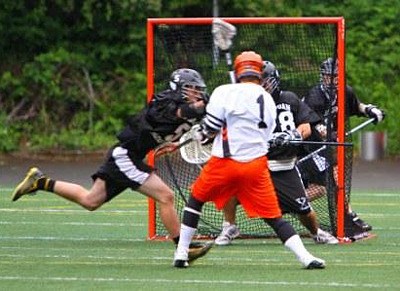 Lynnwood’s Trey Knowles connects for the first of his two first-quarter goals in the Division II lacrosse state championship game at Seattle’s Memorial Stadium.