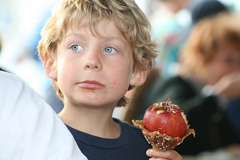 Tanner Wilson enjoys a candied apple at the 2009 San Juan County Fair. The 2010 fair is Aug. 18-21.