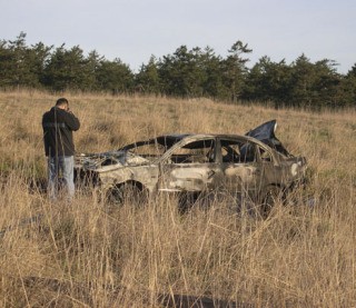 Sheriff's Deputy Felix Menjivar photographs the wreckage of a Volkswagen Passat