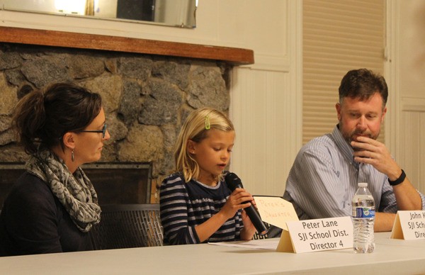 Josephine Lane reads Peter Lane's statement at the League of Women Voters forum Oct. 6. From left