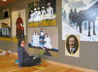 Friday Harbor artist Annie Howell-Adams sits beside the mural that she created for San Juan Island's Peace Island Medical Center. She was recently chosen to create a similar mural for PeaceHealth's hospital in Bellingham.