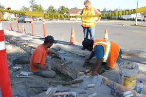 Sidewalk serenade: workers with Lawson Construction put finishing touches on a new sidewalk near the intersection of Spring and Mullis streets in early autumn. The street improvement was funded by the Town of Friday Harbor.