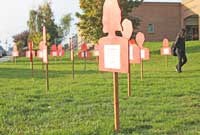 Silhouettes on the courthouse lawn represent and tell the story of victims of domestic violence in Washington state in 2013.