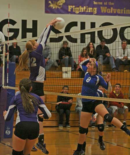 Friday Harbor's Allie Galt rises to block a shot by the Vikings Bella Nigretto