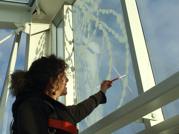 Dana Lynn Louis works on her installation in the San Juan Islands Museum of Art museum atrium.