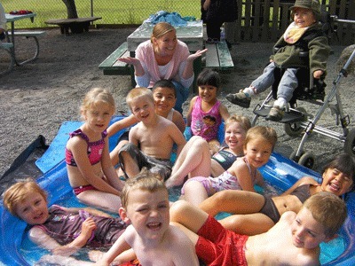 San Juan Island's Head Start students enjoy a dip in an inflatable pool