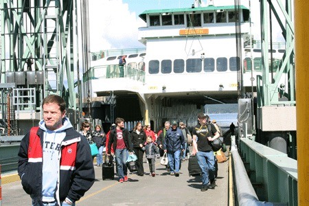 Foot passengers disembark the inter-island ferry at the Friday Harbor ferry landing. The inter-island boat