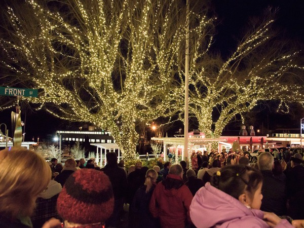 Bystanders watch the tree lighting on Spring and Front Street.