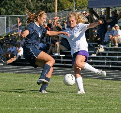 Friday Harbor's Robyn Roberts battles for the ball in the Wolverines season opener