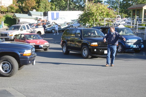 Sheriff Bill Cumming directs traffic while the 6:10 p.m. ferry offloads Friday in Friday Harbor. Some $230