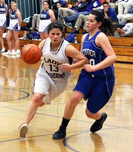 Friday Harbor's Larissa Nash clears a path to the basket on the way to dropping in two of her 11 points in the Wolverines 55-41 win over La Conner Saturday in Turnbull Gym. Friday Harbor faces the Knights of Kings High School Wednesday in the opening round of post-season play.
