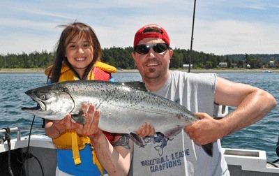 Andy Holman and daughter Alexandria display a nice-sized salmon and a pair of 'salmon smiles'.