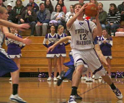Junior Donald Galt turns a steal into a two-point layup in early season action at home against South Whidbey. Galt