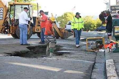 Town of Friday Harbor employees work on patching a hole on Spring Street early Sunday