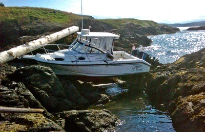 D' Boat on d-rocks... the skipper of this 22-foot Boston Whaler