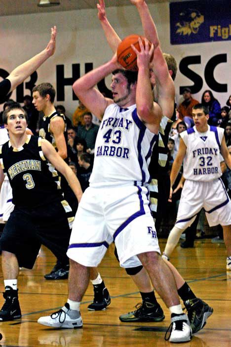 Parker Lawson draws a crowd as the Meridian defense tries to clamp down on Friday Harbor's leading scorer. Lawson tallied 17 points and grabbed 14 rebounds in a 57-52 defeat at home Wednesday by the Trojans.