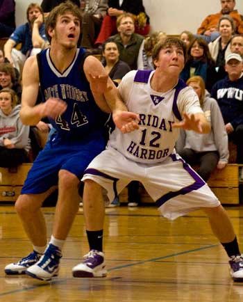 Friday Harbor junior Donald Galt battles for rebounding position against South Whidbey's big man