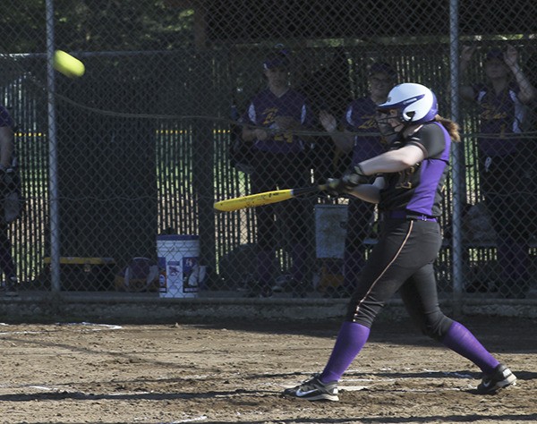 Wolverines softball player takes a swing.