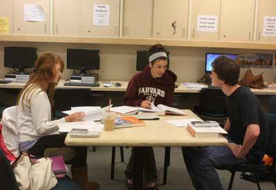 Senior Megan Goudie (center) and fellow classmates take advantage of resources in Friday Harbor High School's college counseling center in preparing for their academic future. The center would lose two hours of staff support each day under the district's proposed budget cuts for the coming school year.